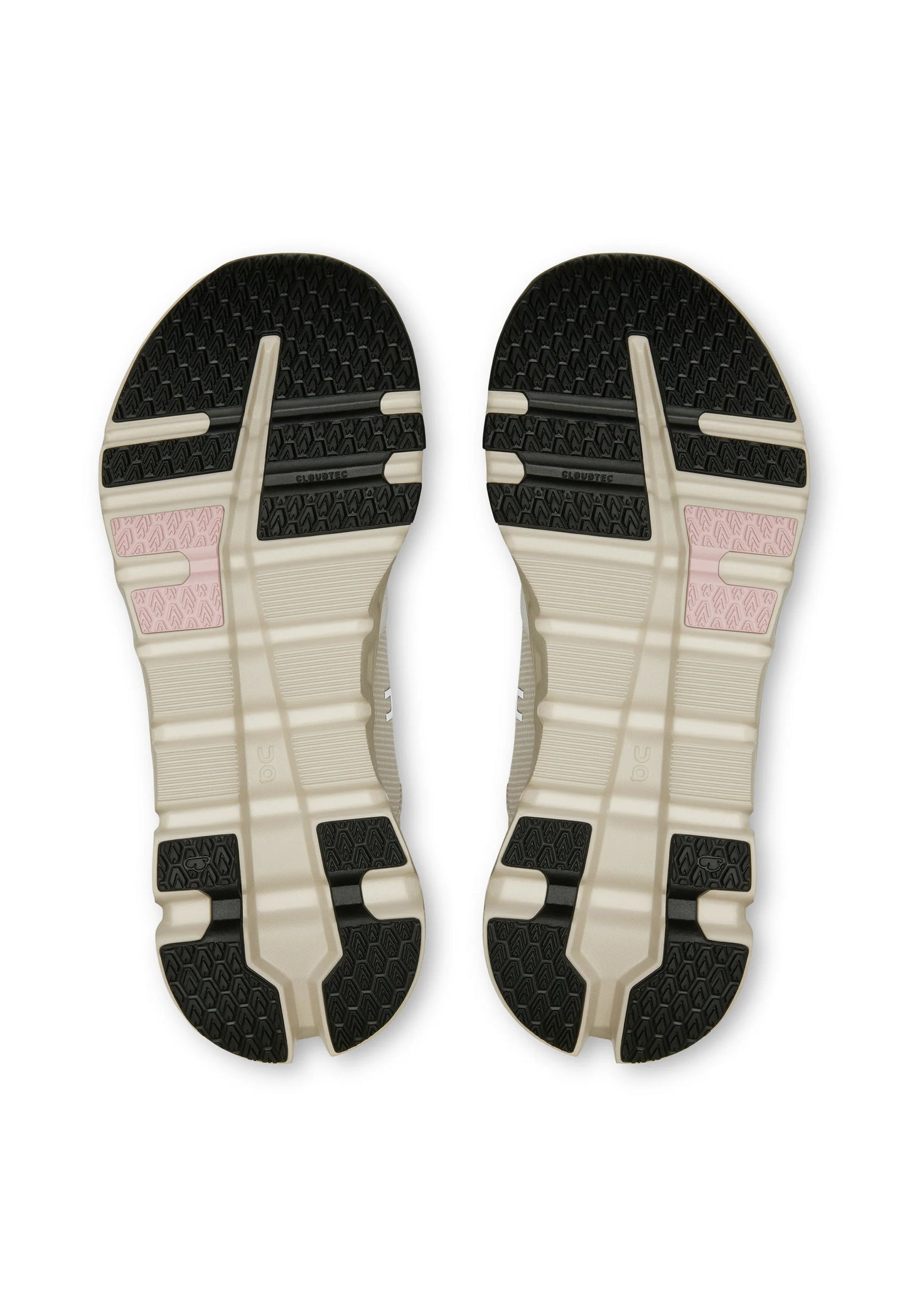 Suole delle scarpe con base beige, motivi di battistrada neri e piccole sezioni di grip rosa, mostrando un design simmetrico e il marchio "Cloudtec".